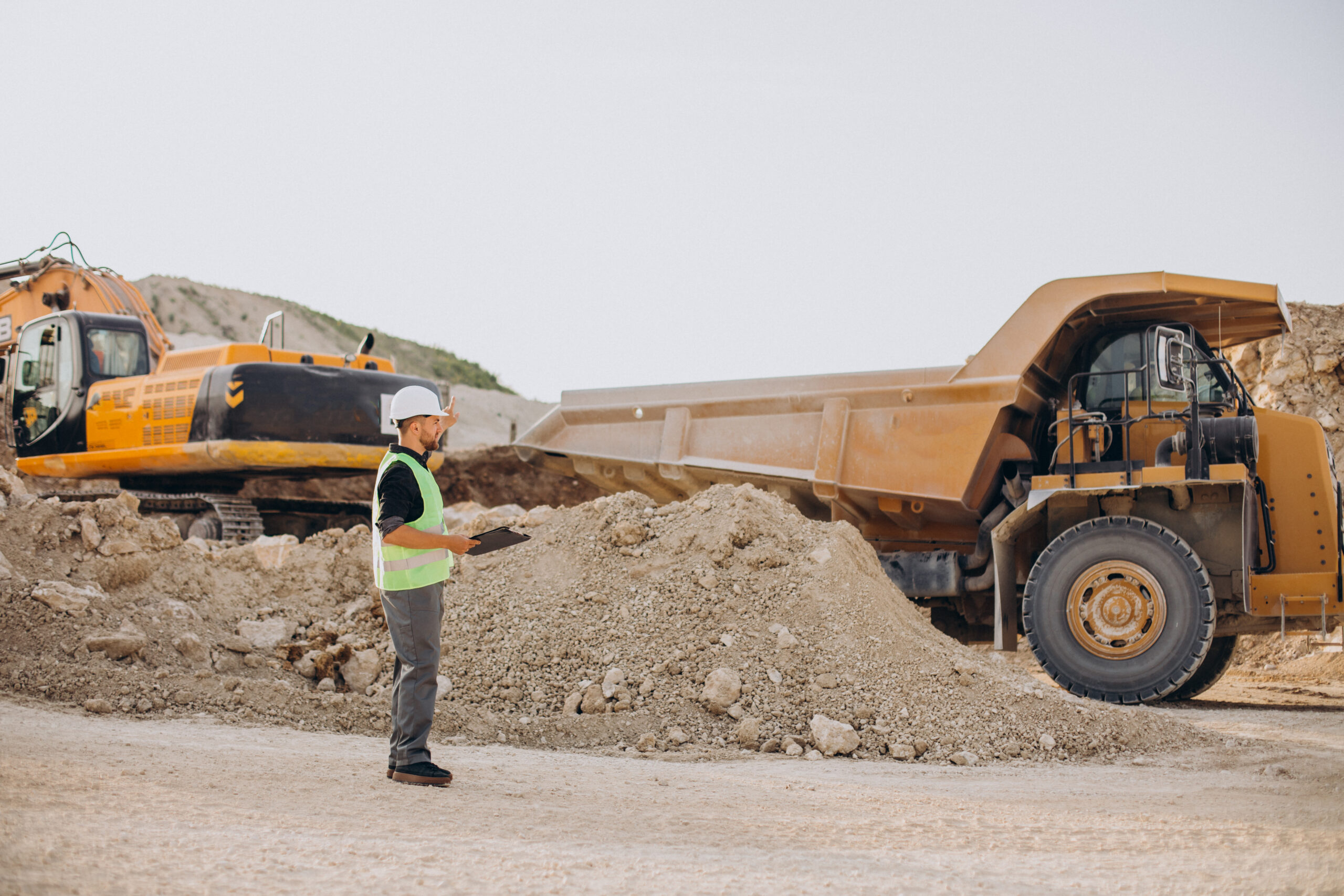 Male worker with bulldozer in sand quarry